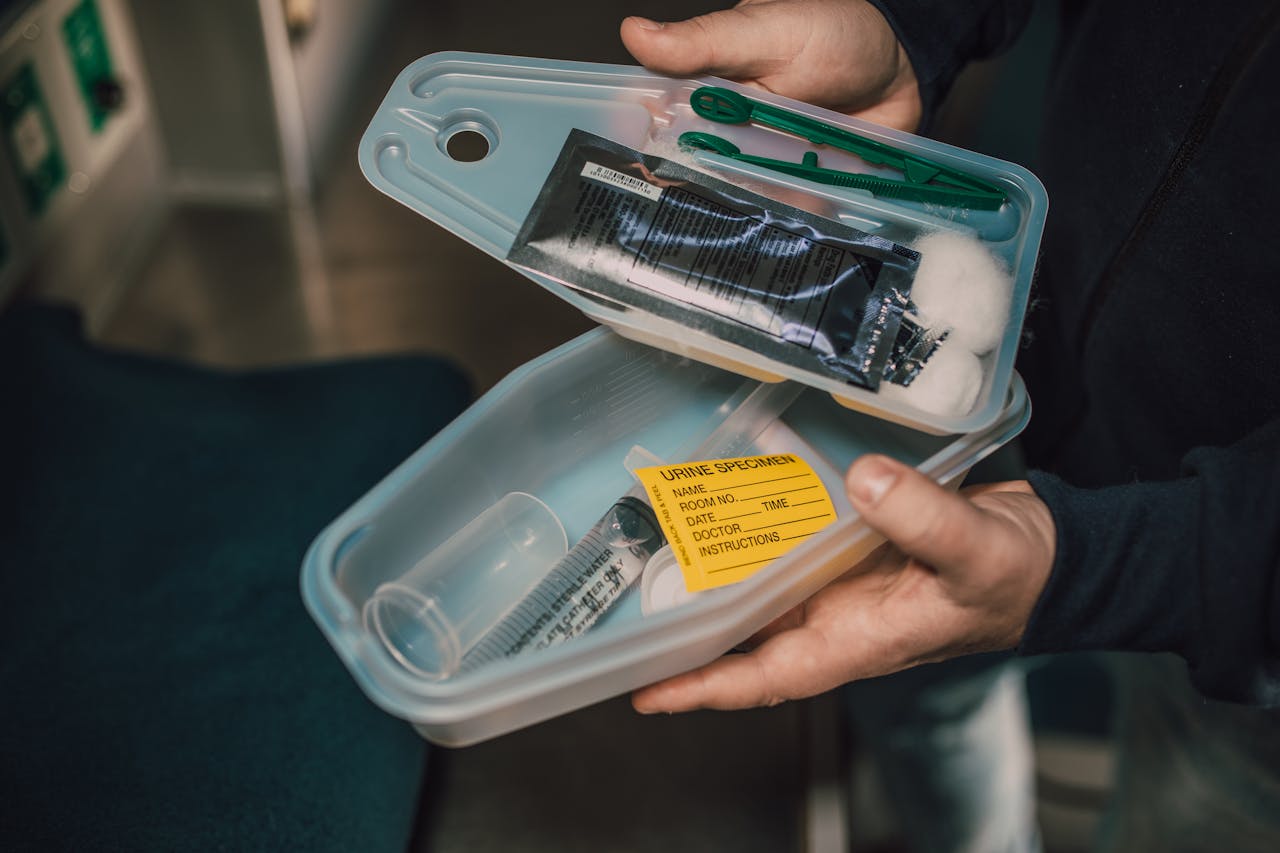 Close-up of medical kit containing syringe and urine specimen label.